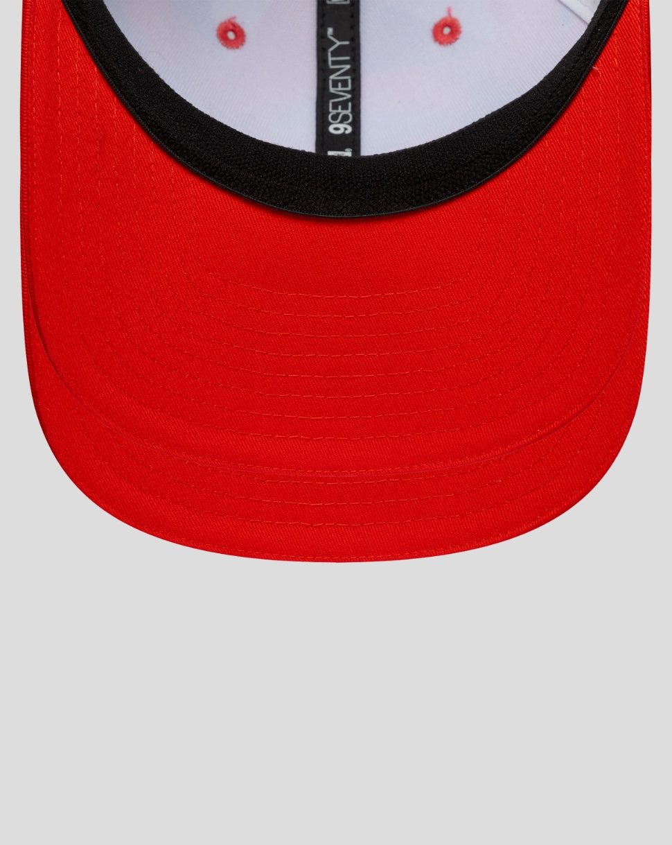 Front view of a red curved brim cap with a black inner edge along the face opening.