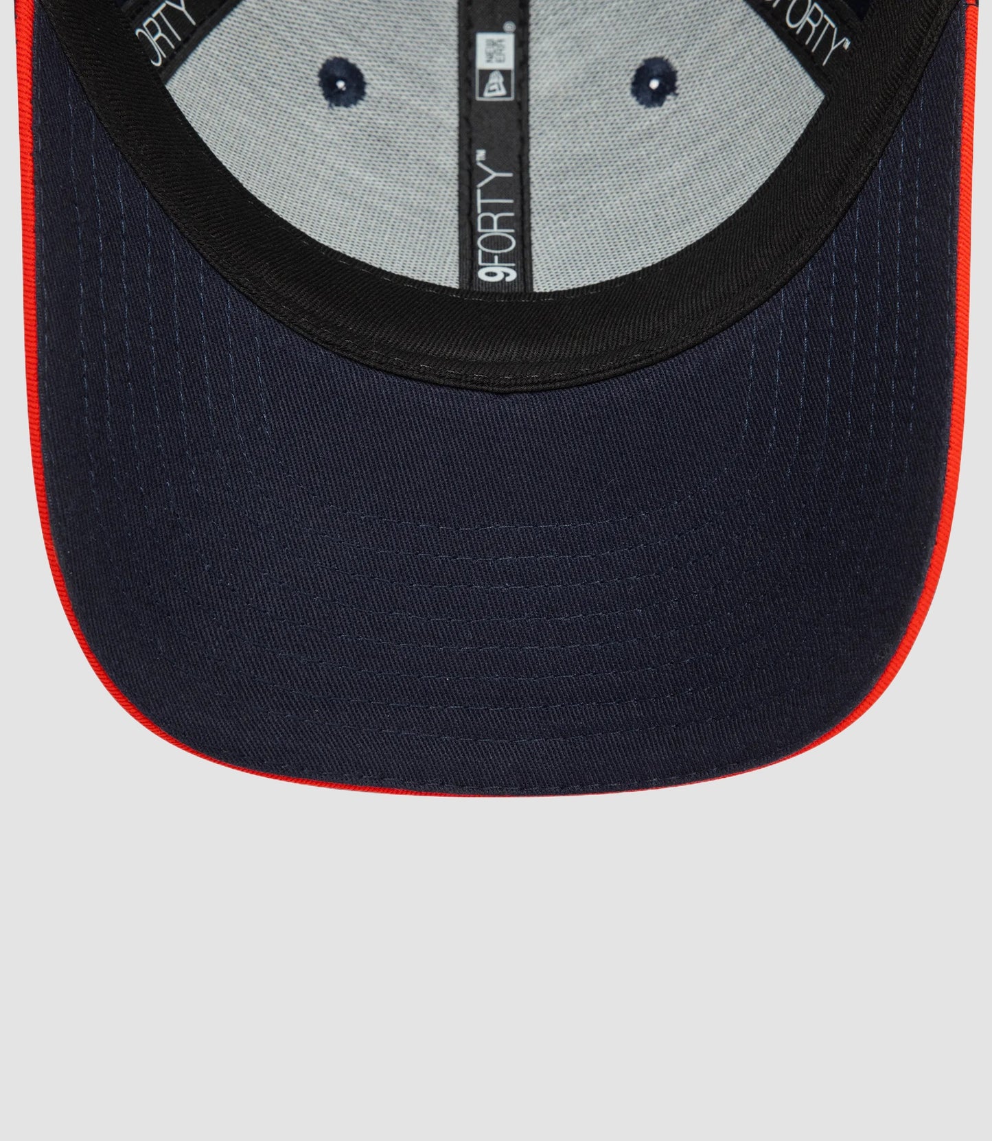 Close up of Oracle Red Bull Racing Team 9Forty cap showing navy fabric with red piping and a central 9Forty label