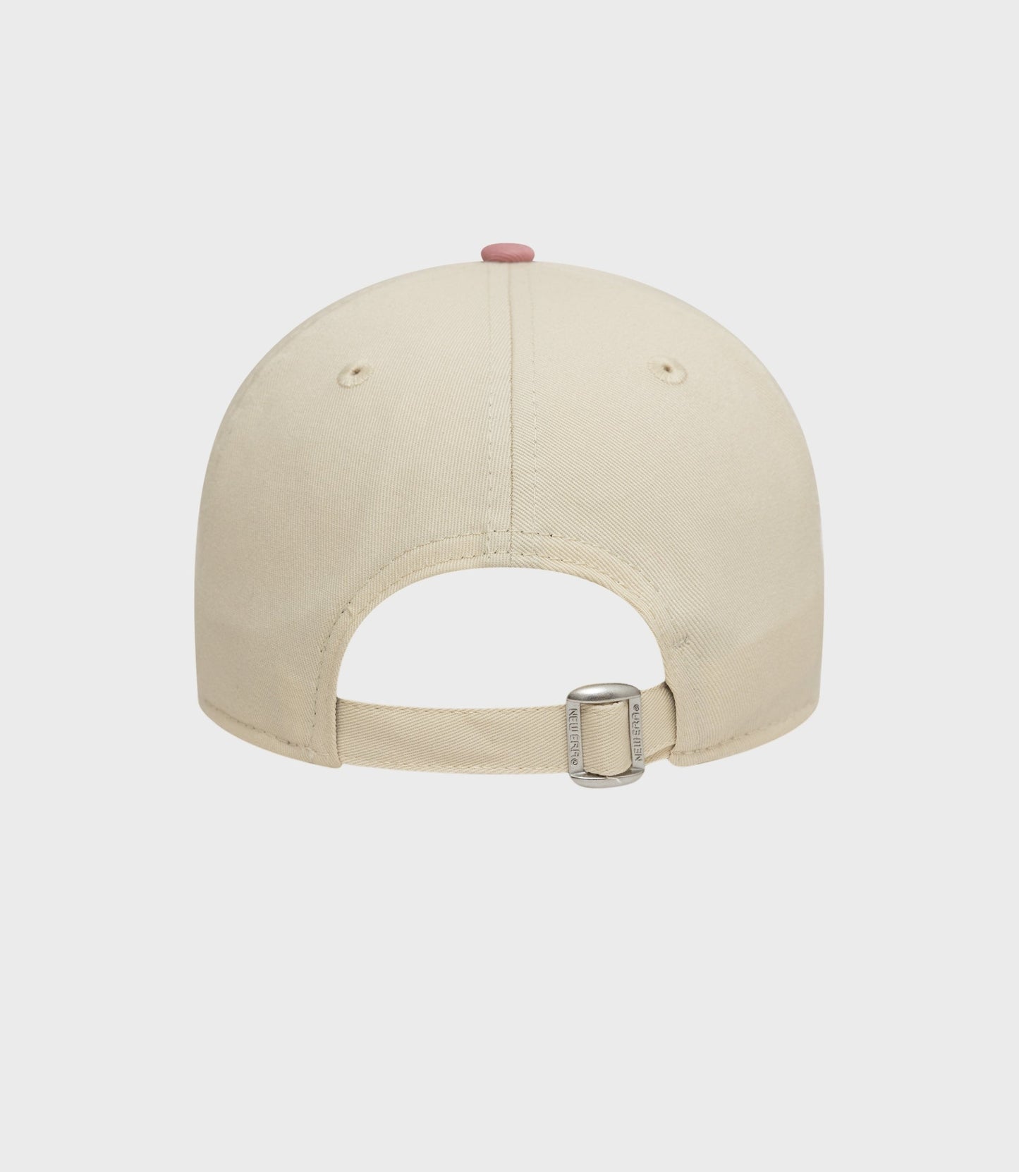 Back view of a light beige New Era cap with an adjustable cotton strap and pink top button.