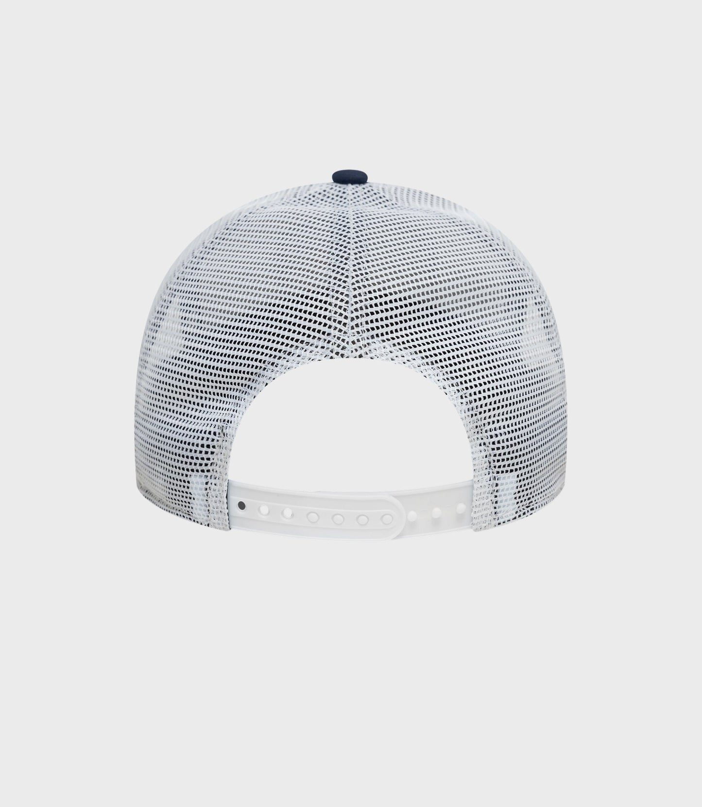 Top view of white mesh trucker cap showing navy button and breathable mesh crown