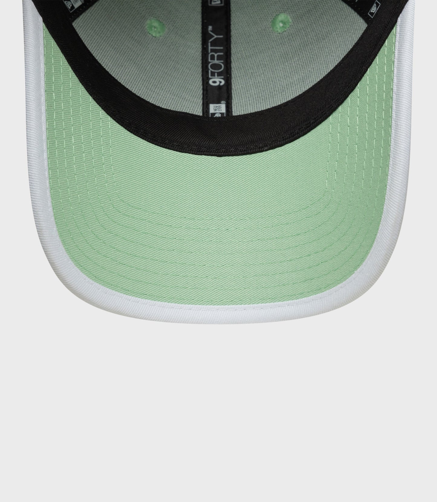 Back view of pastel green cap showing adjustable strap and metal buckle