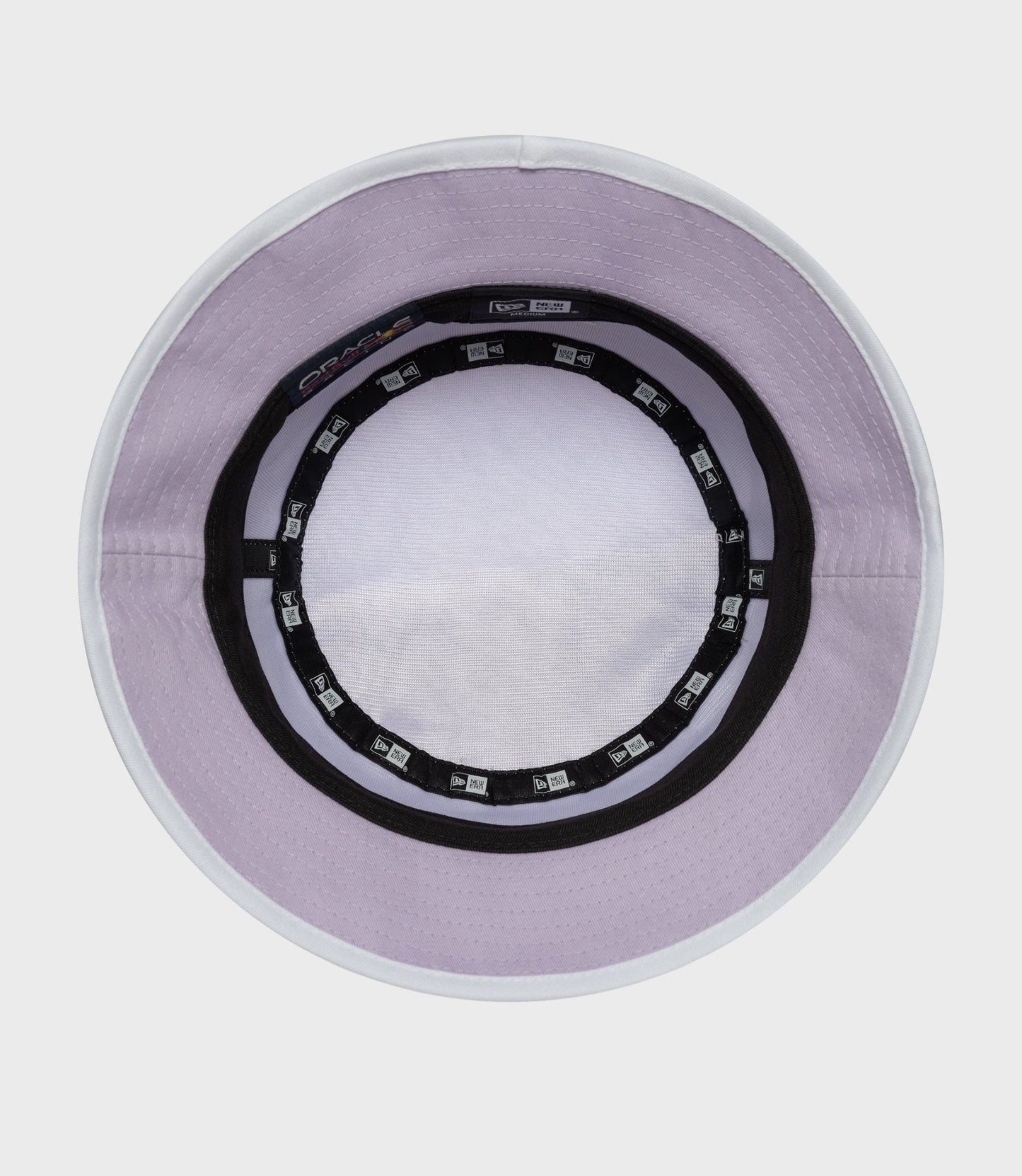 Inside rim of pastel purple bucket hat with white edge and New Era branding tags around the inner band