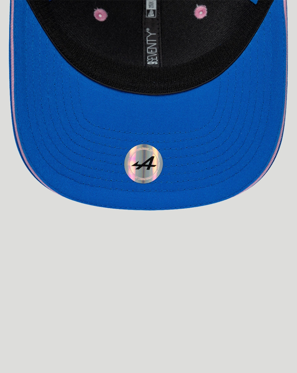 Blue crown with black front panel New Era 9Seventy cap showing BWT Alpine branding, stretch-snap back, blue brim with pink edge.