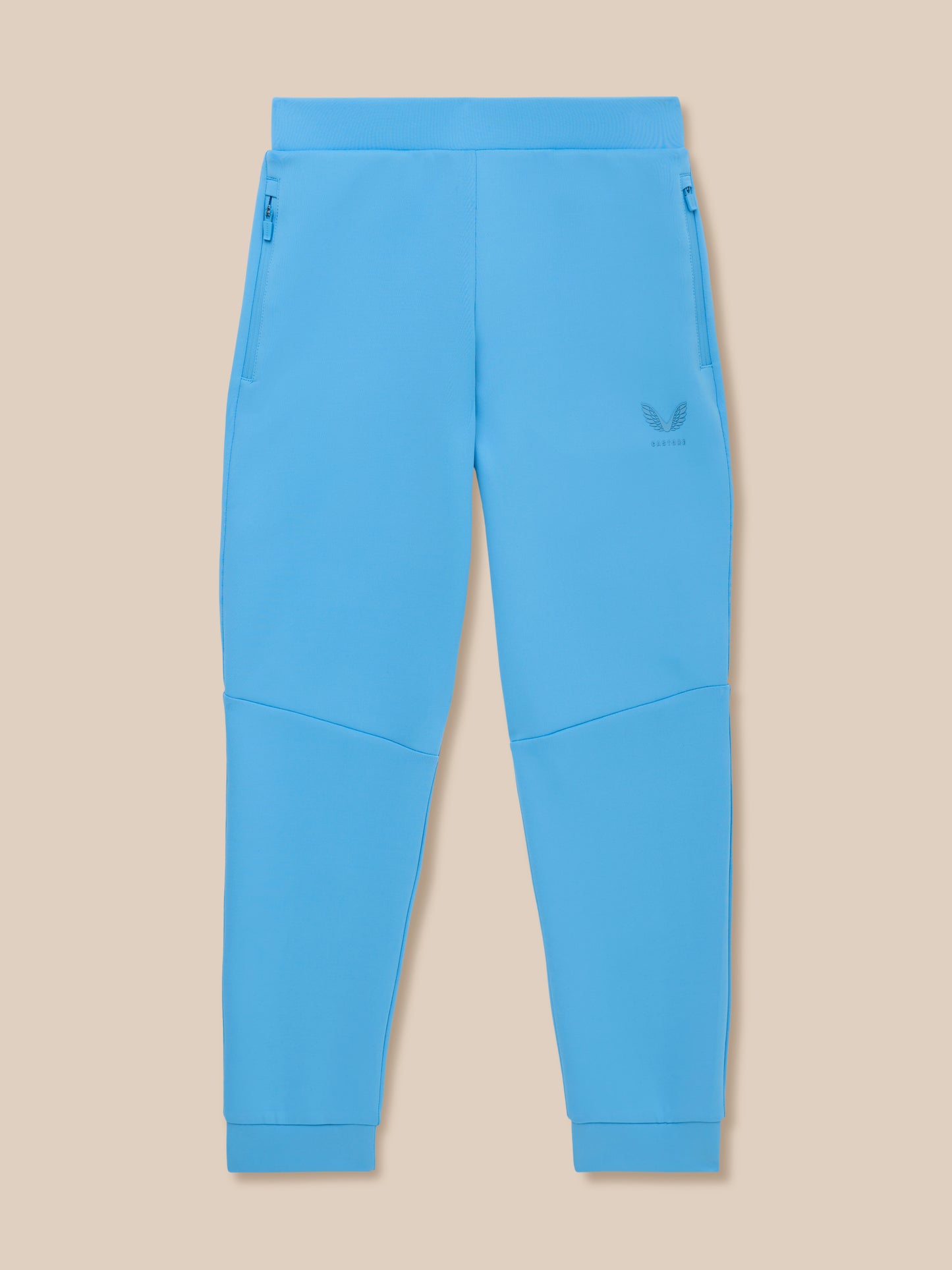 Bright blue junior Flex scuba trousers with zip pockets and Castore logo on the left leg.