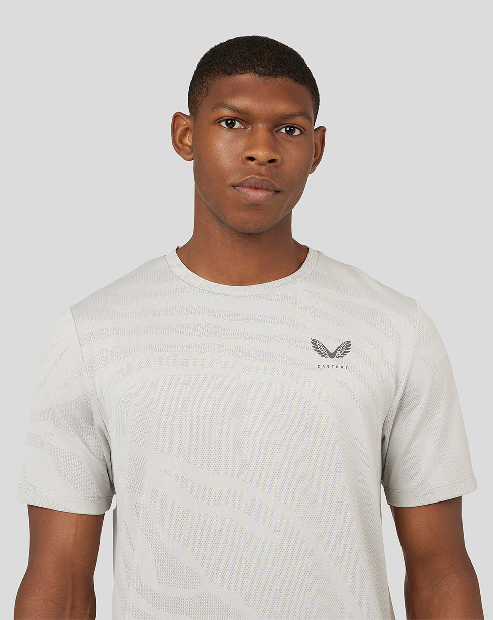 Front view of Oyster white Core Tech T Shirt with subtle pattern and Castore logo on left chest.