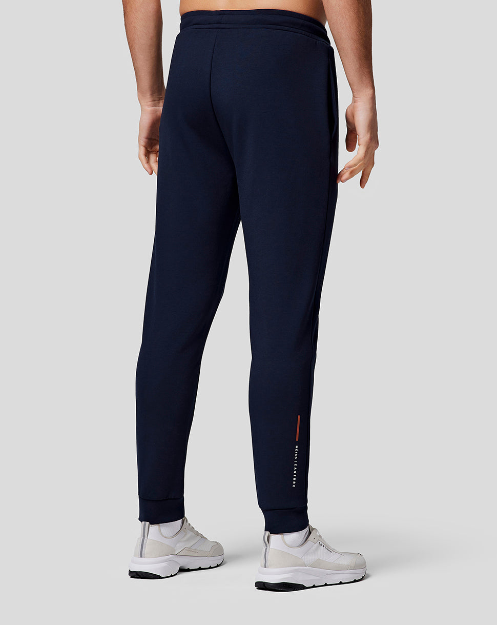 Back view of midnight navy men's recovery joggers with a tapered leg and cuffed hems, Castore branding on the lower right leg.