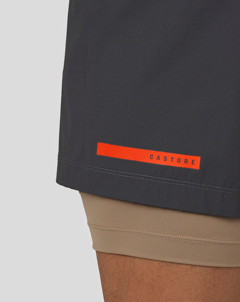 Back view of navy Flow Shorts with bright orange Castore label on the back left thigh
