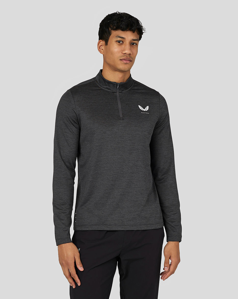 Male model wearing gunmetal marl long sleeve quarter zip top with funnel neck and chest logo