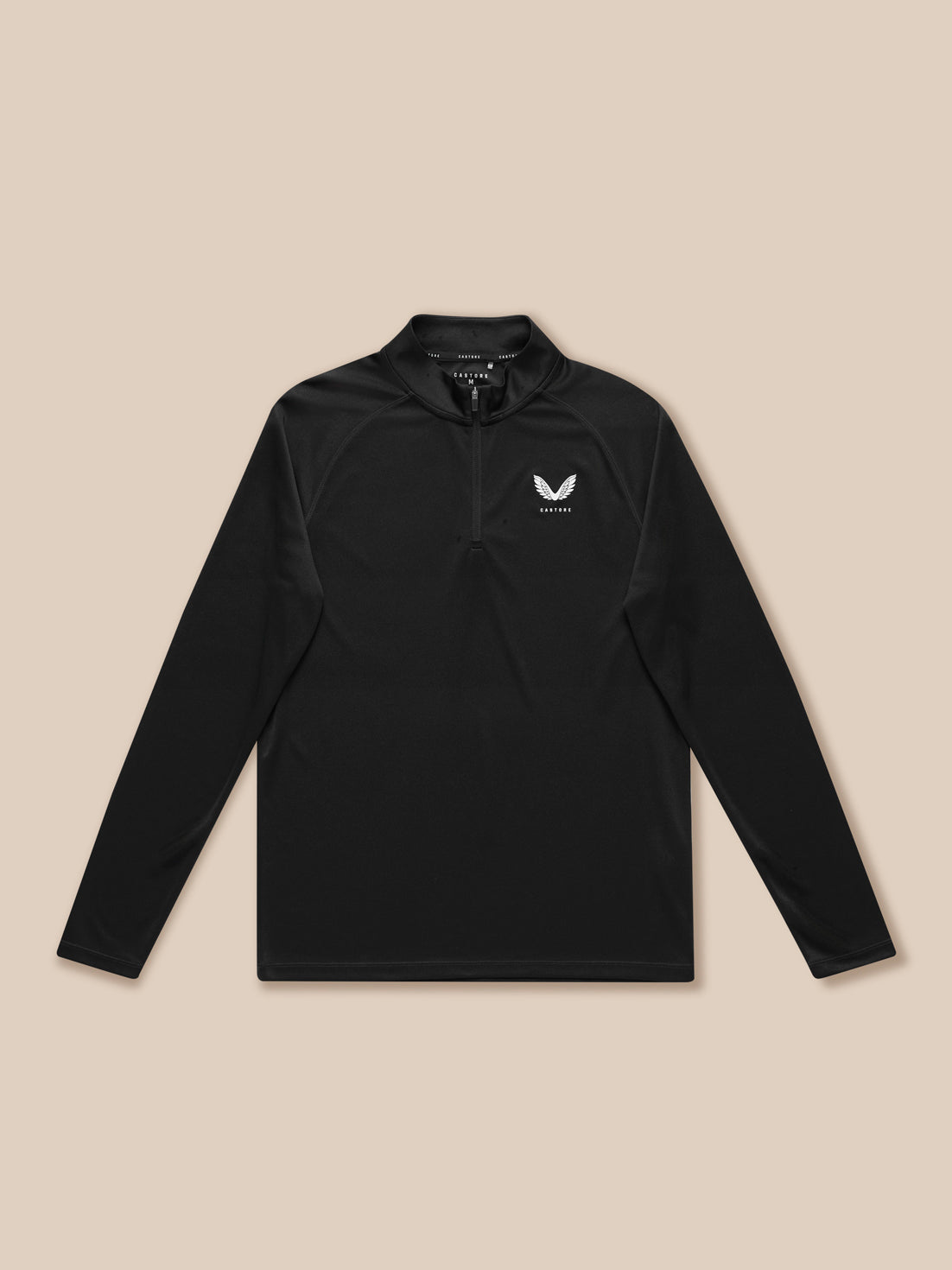 Black Adapt Training quarter zip top laid flat with left chest Castore logo on a tan backdrop