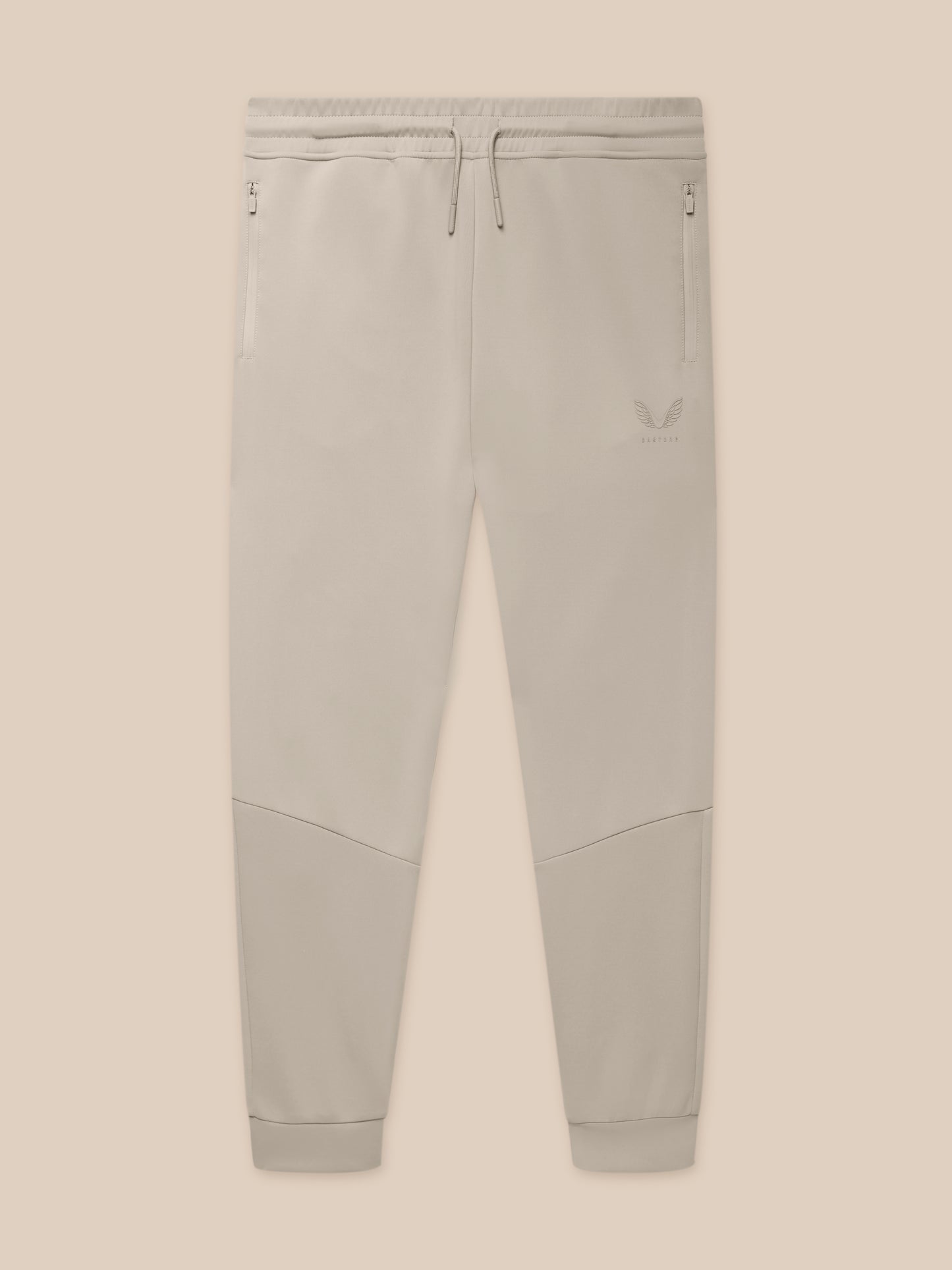 Close-up of waistband with drawcords and zip pockets on Rock Grey joggers with logo on the thigh