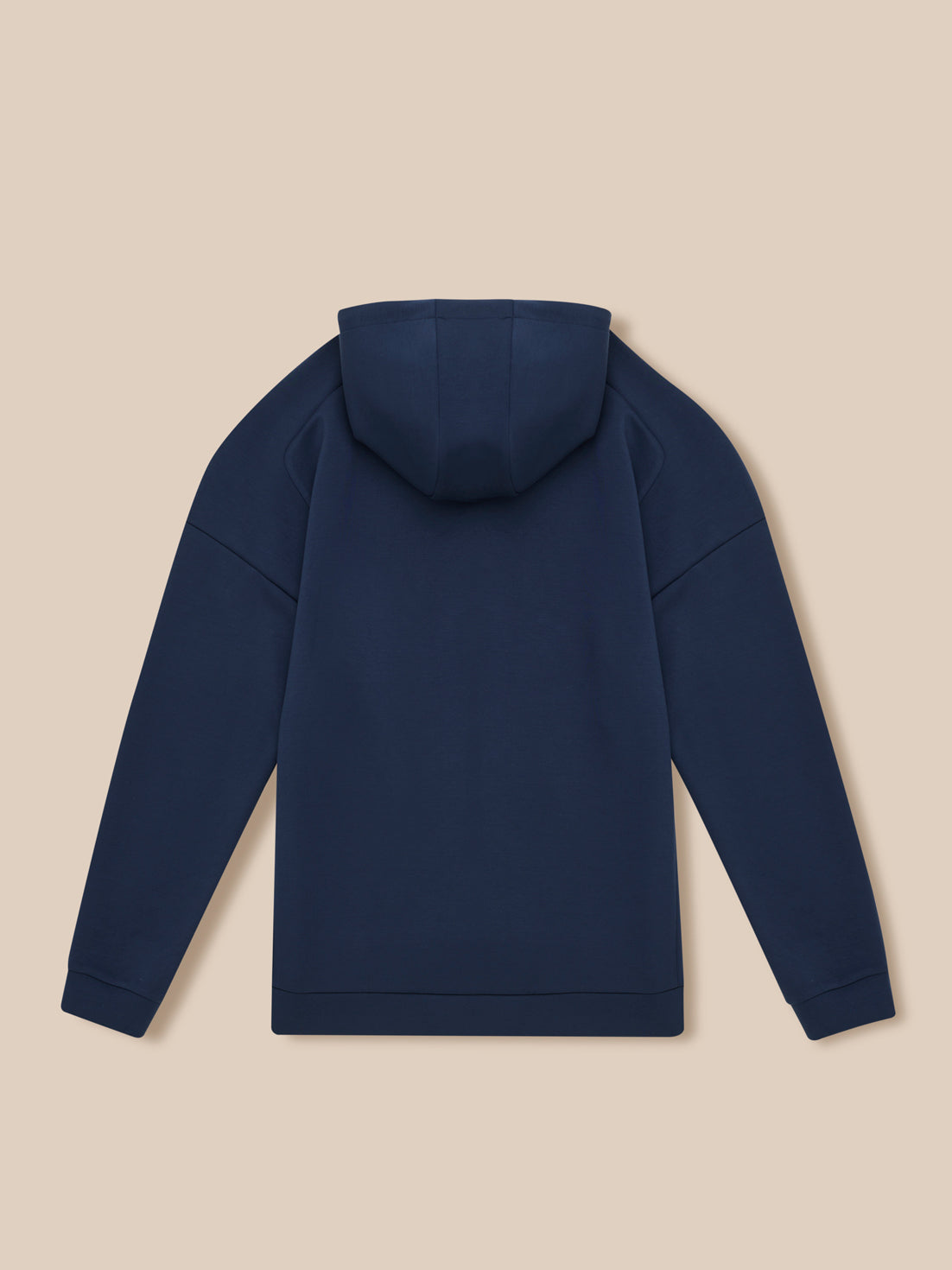 Back view of navy Travel Lifestyle Zip Hoodie with hood up on beige background.