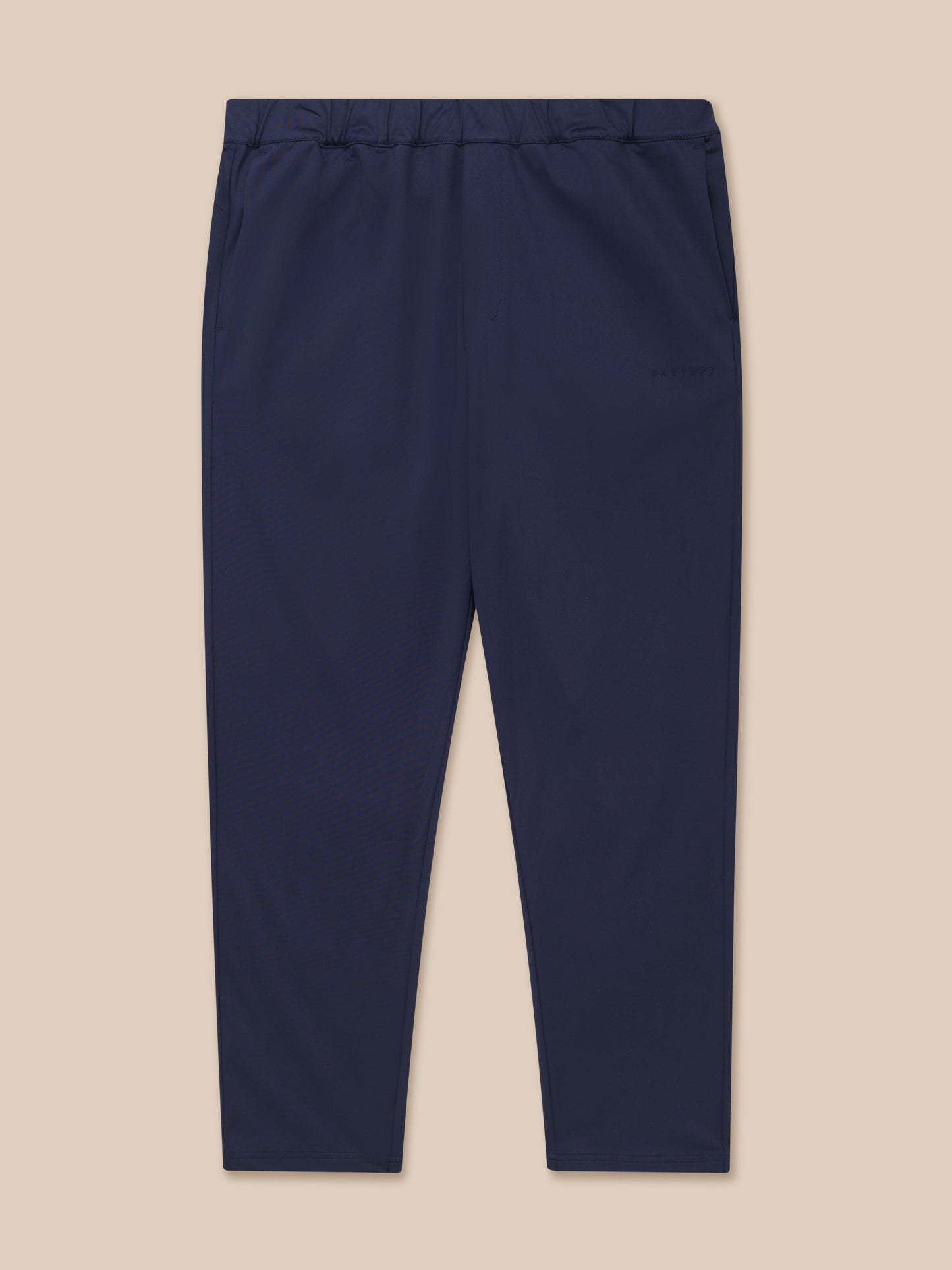 Navy tailored trousers shown from the back waist with elastic waistband and back yoke zipped pocket, Castore branding on the left leg