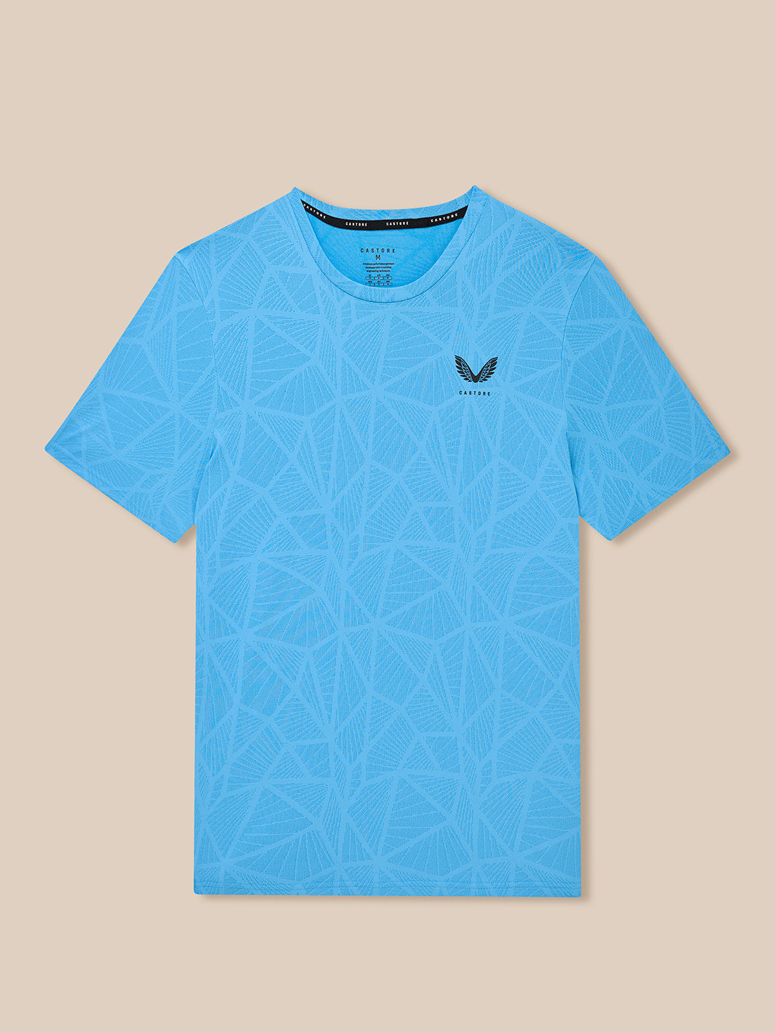 Flat lay of blue Flow Training Engineered Knit T Shirt with allover geometric pattern and Castore logo on left chest