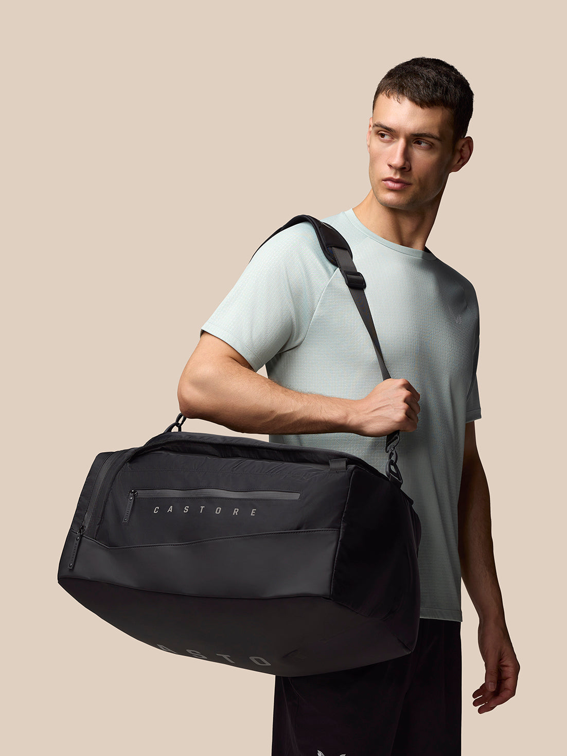 Side view of black Pursuit Large Backpack worn by model