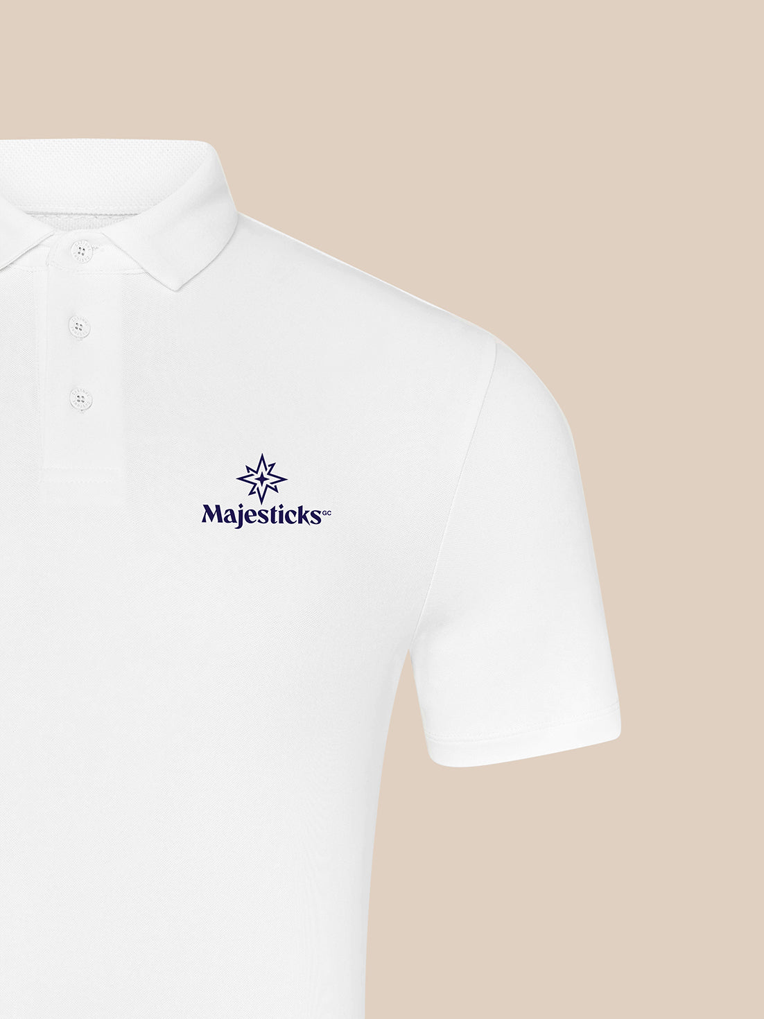 Majesticks white polo with three-button placket and left chest logo visible on fabric close-up
