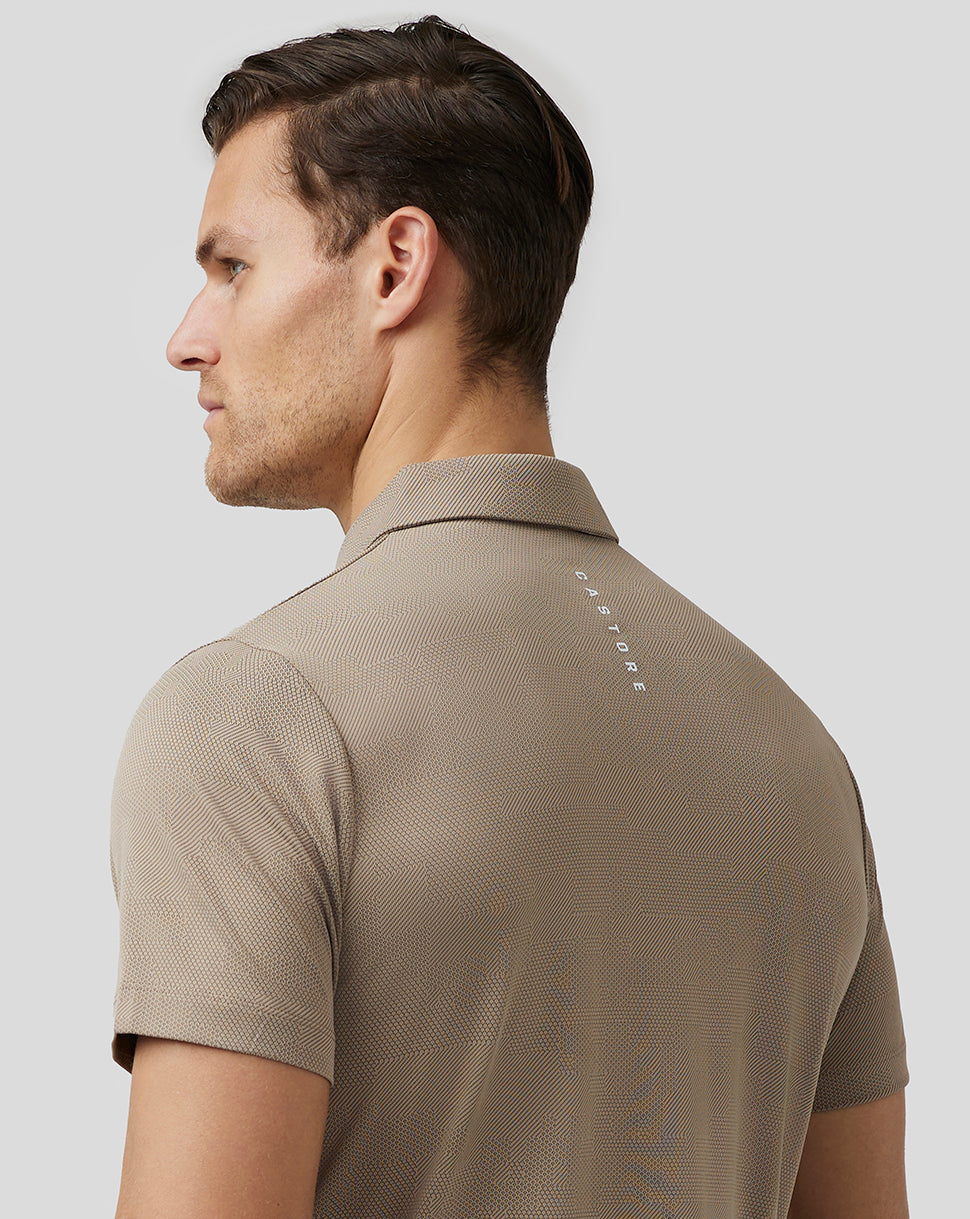 Back view of beige Pinnacle Knit Polo with Aertek branding at lower back and Castore logo at upper back