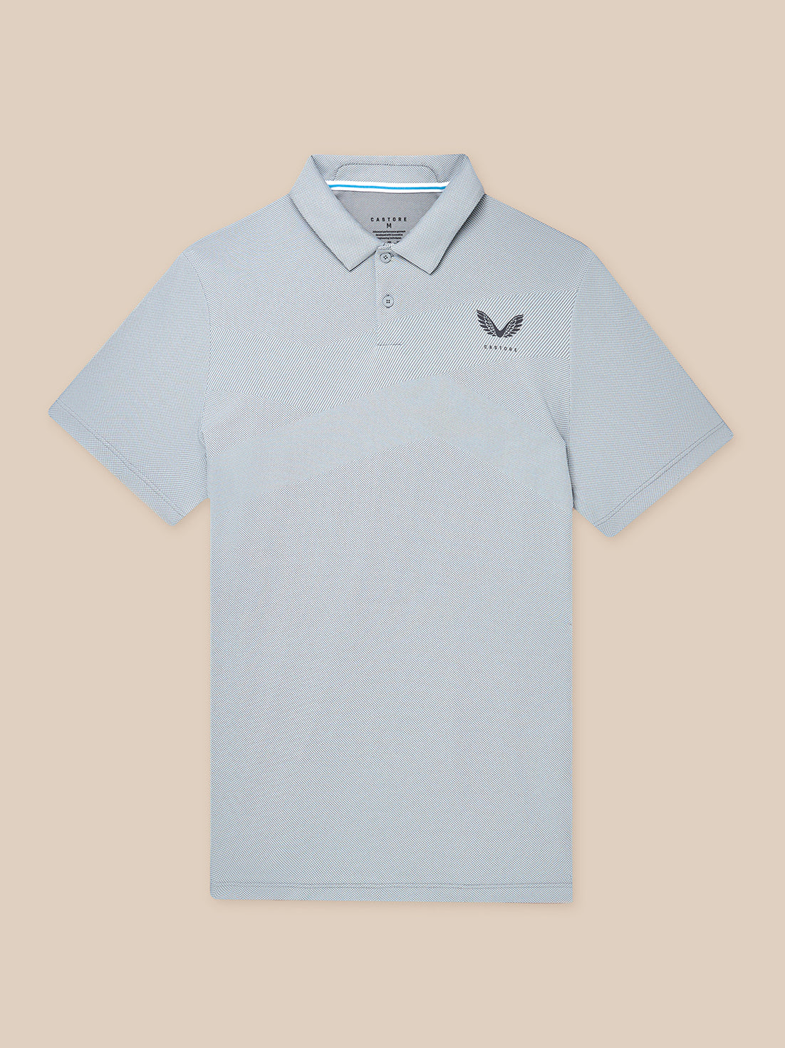 Male model wearing light grey Engineered Knit Polo with chest logo and breathable knit pattern.
