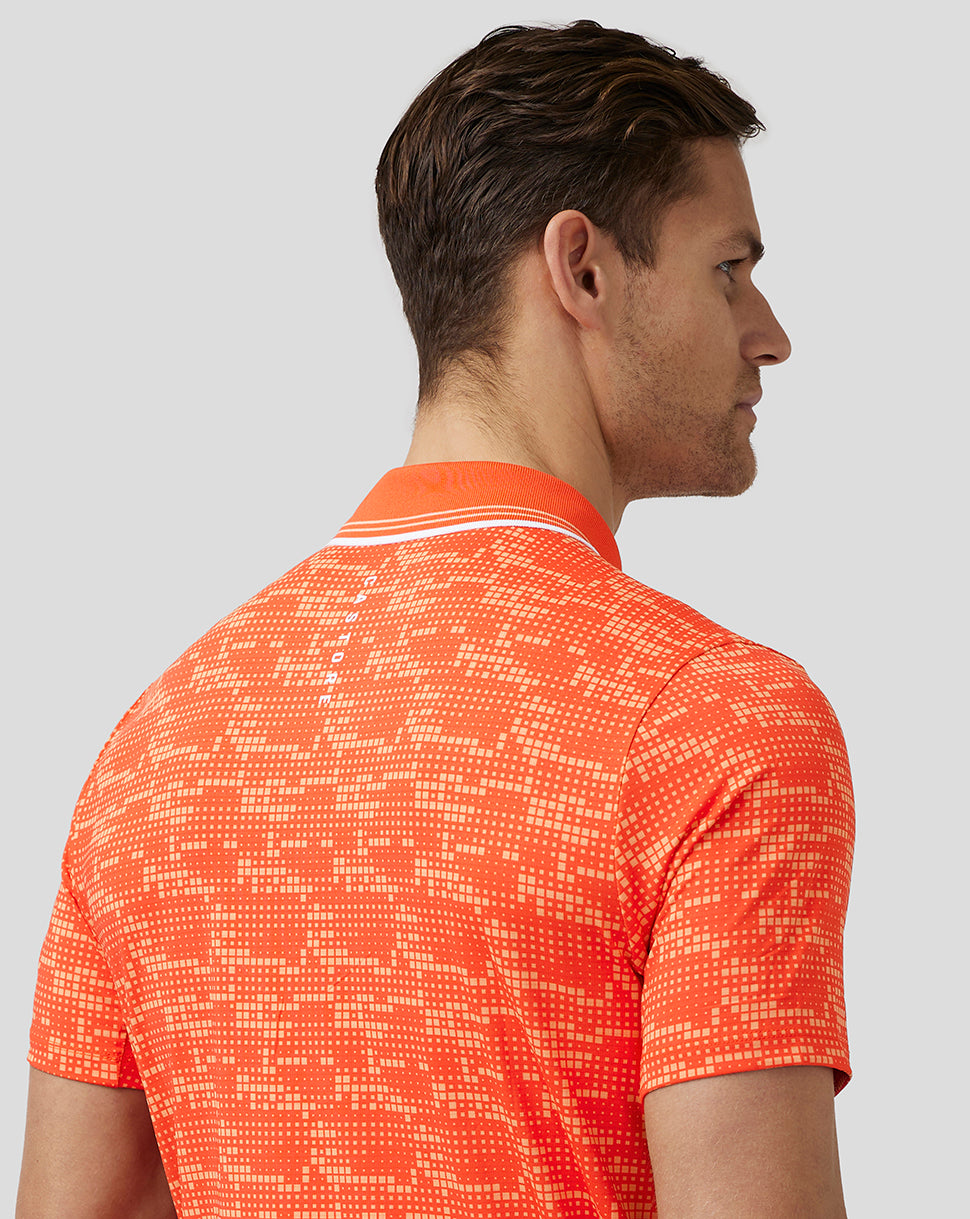 Profile view of a man in the same deep orange golf printed polo, showing the back of the collar and the pixel pattern.