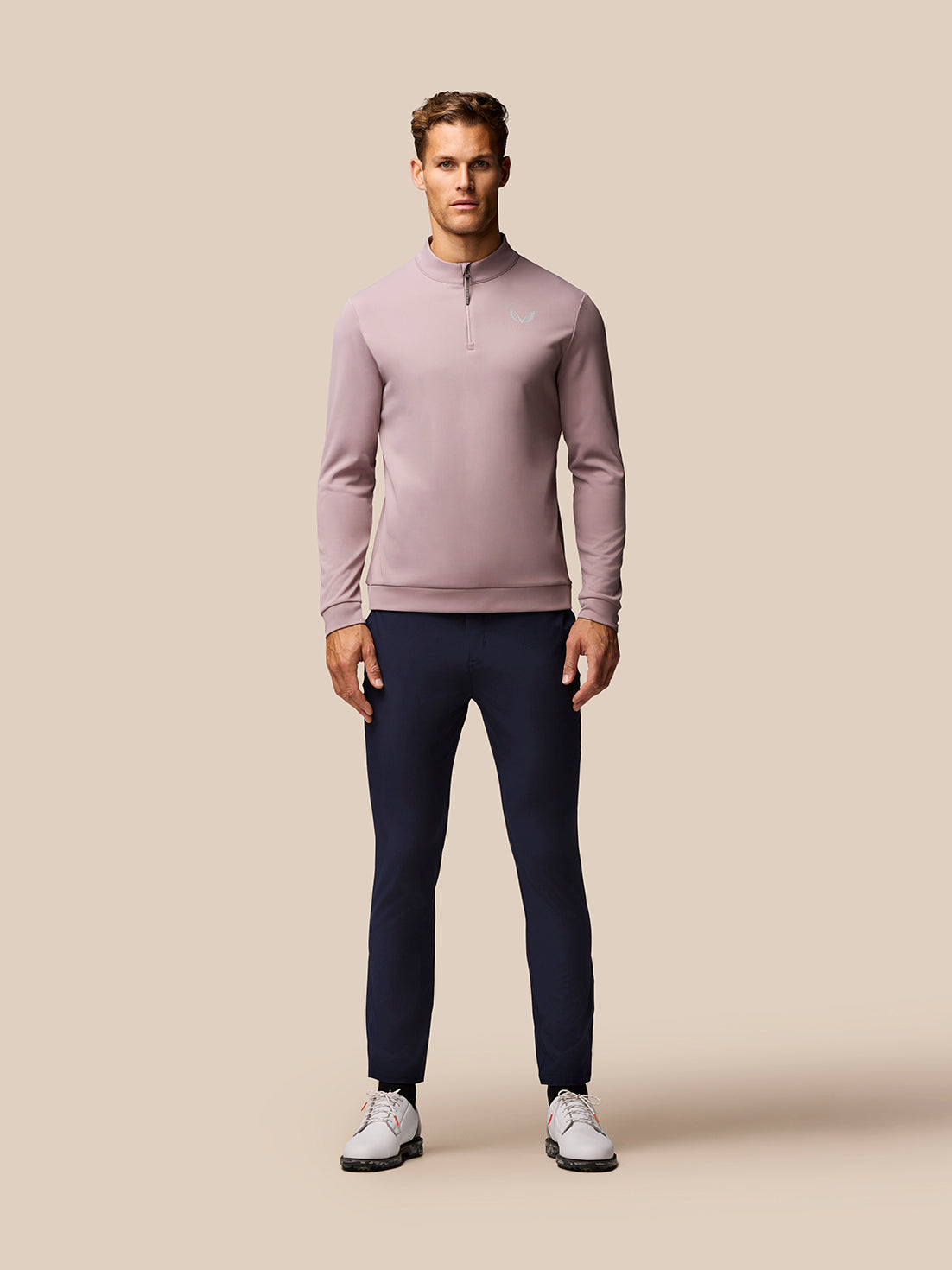 Detail of pink Club Golf 1/4 Zip Top back with vertical CASTORE branding along the spine