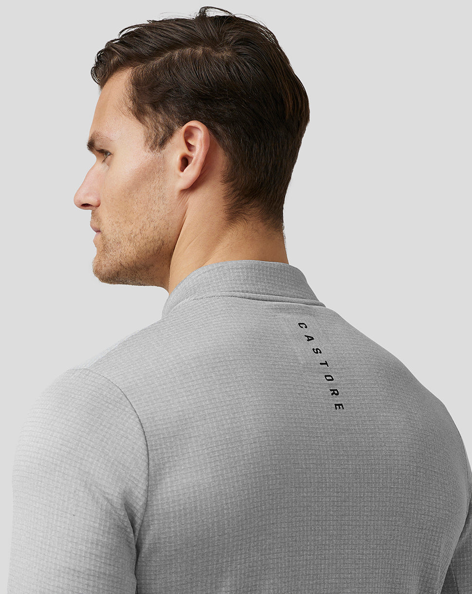 Side back view of the steel grey Pinnacle Tech Half Zip Top on a model showing upper back branding