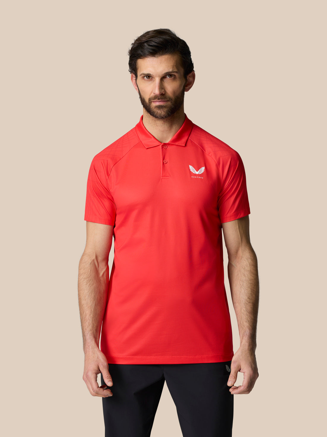 Male model wearing red Club Graphic Polo with polo collar and short sleeves and white logo on left chest.