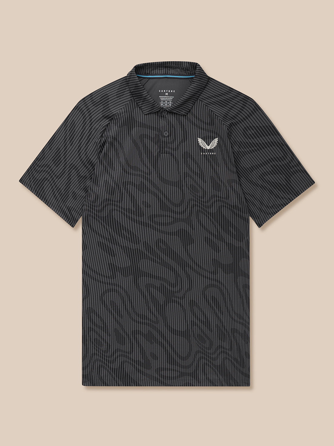 Male model wearing Golf Club Glow Printed Polo in gunmetal grey with all-over print and left chest Castore logo