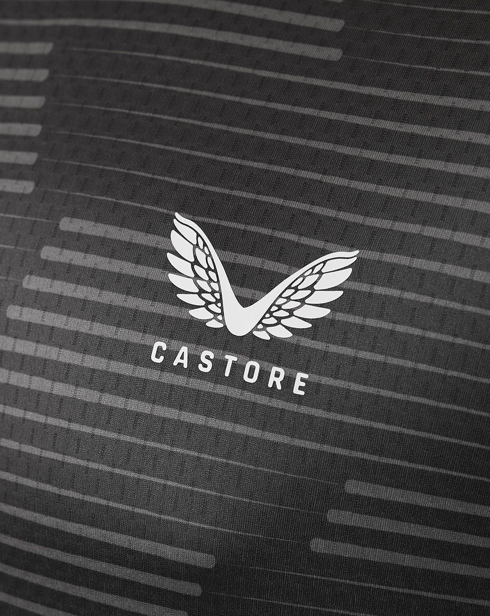 Close up of dark fabric with striped pattern and white Castore wing logo