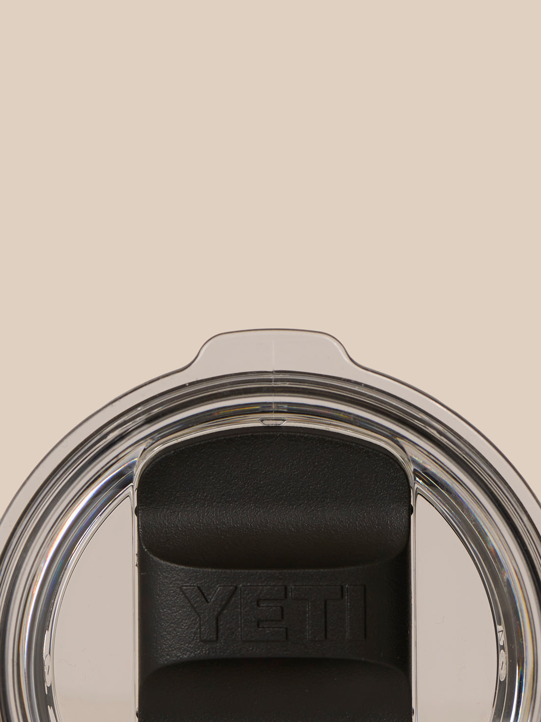 Top close-up of the tumbler lid area showing a clear lid and YETI branding on the black lid component