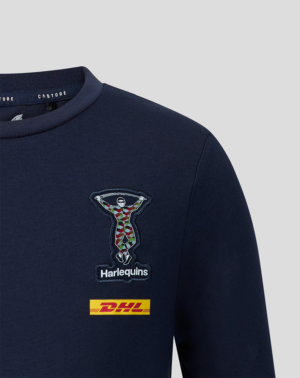 Close up of navy Harlequins junior travel T shirt showing crest embroidery and DHL patch
