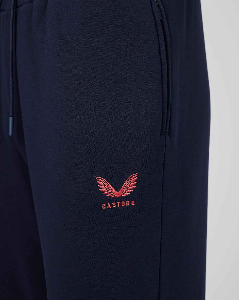 Navy blue pants with a red embroidered logo on a light gray background