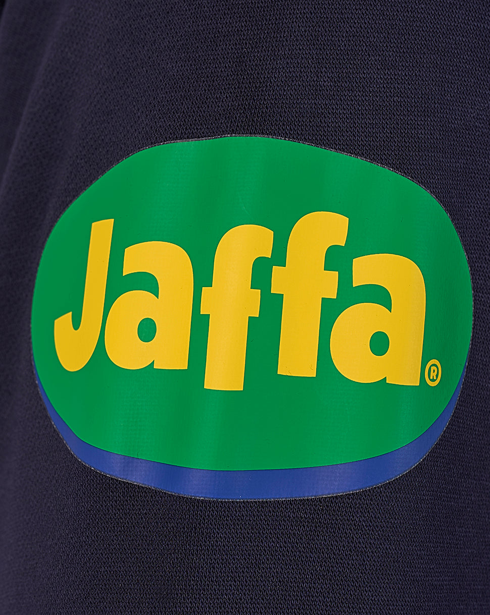 Prominent Jaffa logo patch in green and yellow on dark navy fabric.