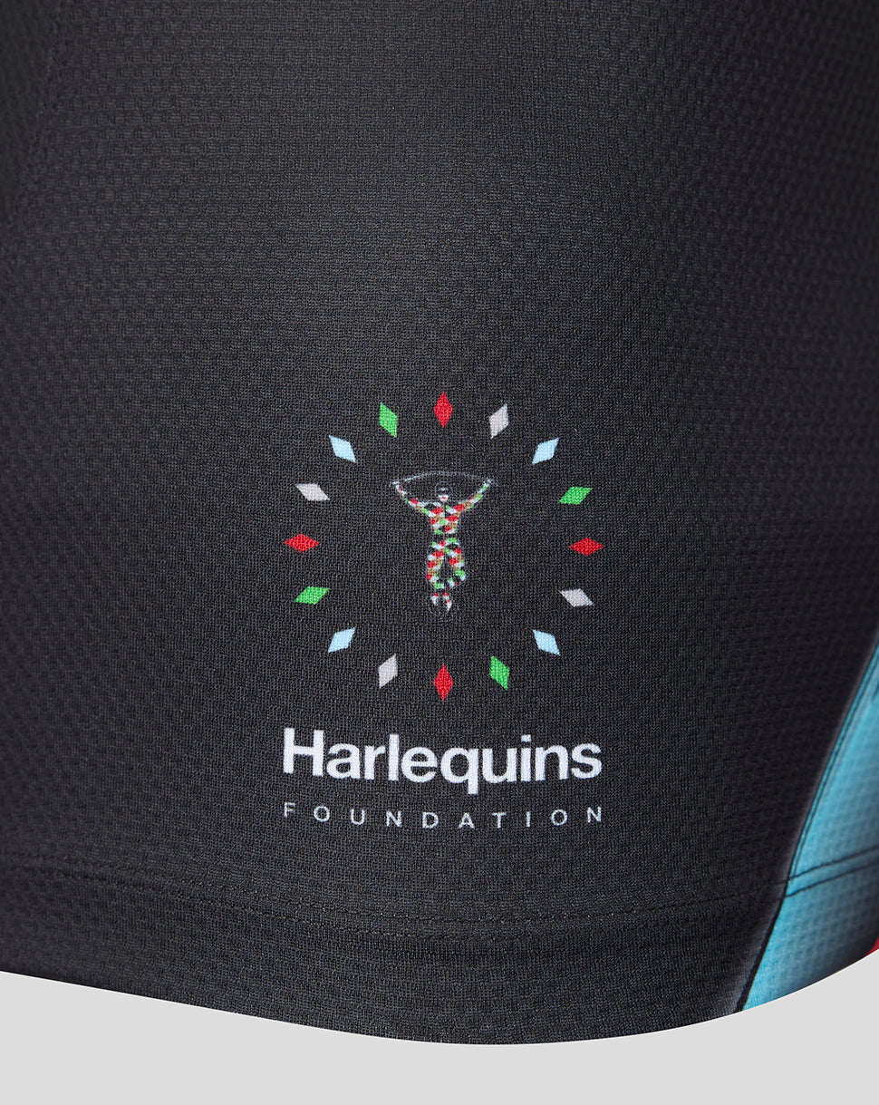 Close-up of a black athletic garment featuring the 'Harlequins Foundation' logo with a colorful DNA helix and white text on the front.