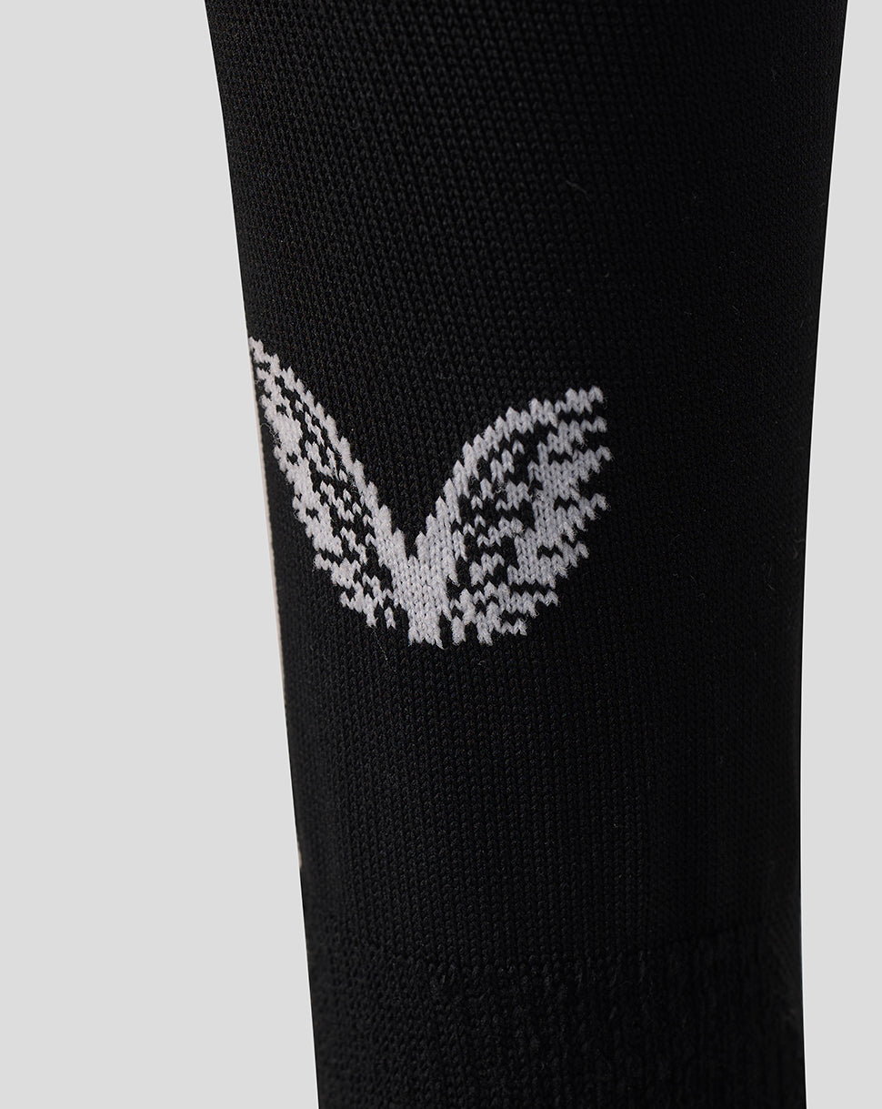Close up of black Harlequins Home Sock with white knitted wing logo