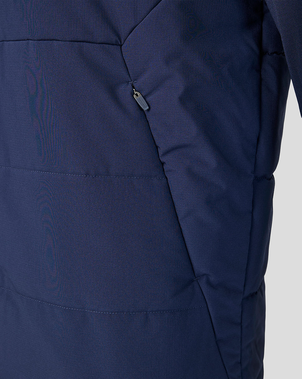 Close-up of a navy blue jacket with a zipper on a light gray background