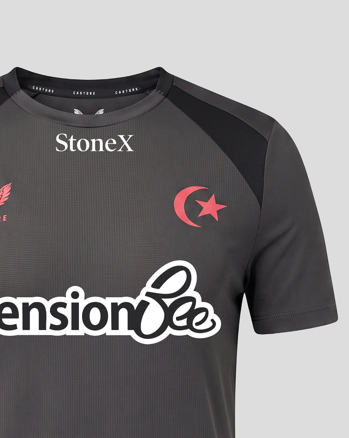 A close-up of a dark gray athletic jersey with black shoulder panels, featuring the white StoneX logo on the chest, a red crescent and star emblem, and a large white 'Pension Bee' sponsor logo across the front.