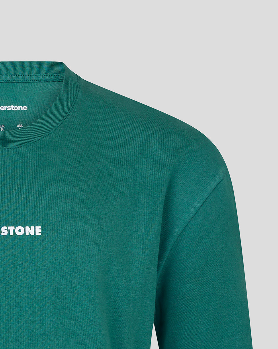 Close-up of a green long-sleeve t-shirt with white 'SILVERSTONE' text on the chest, set against a light gray background.