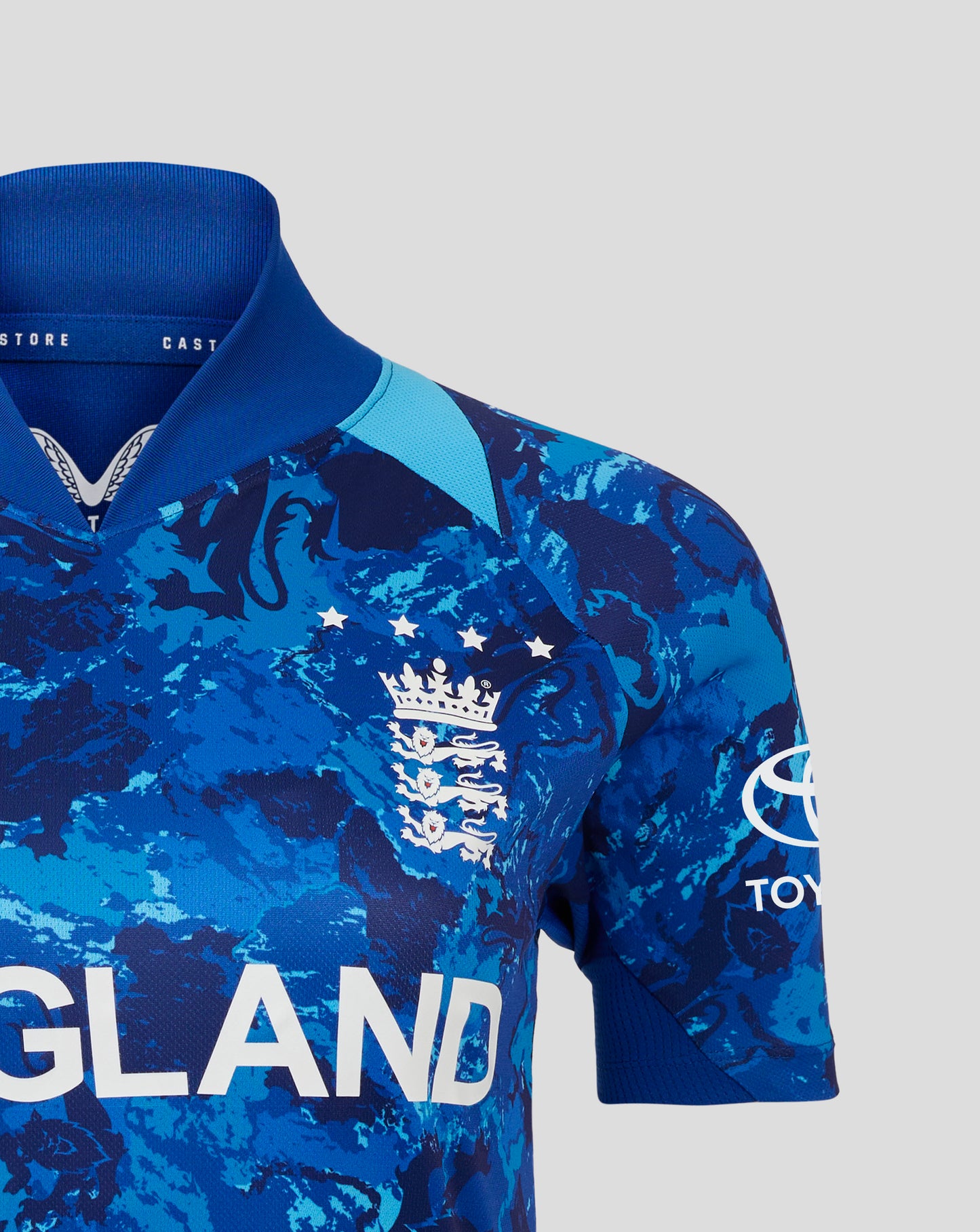 Close up of blue England ODI World Cup women's replica shirt with crest and large ENGLAND lettering