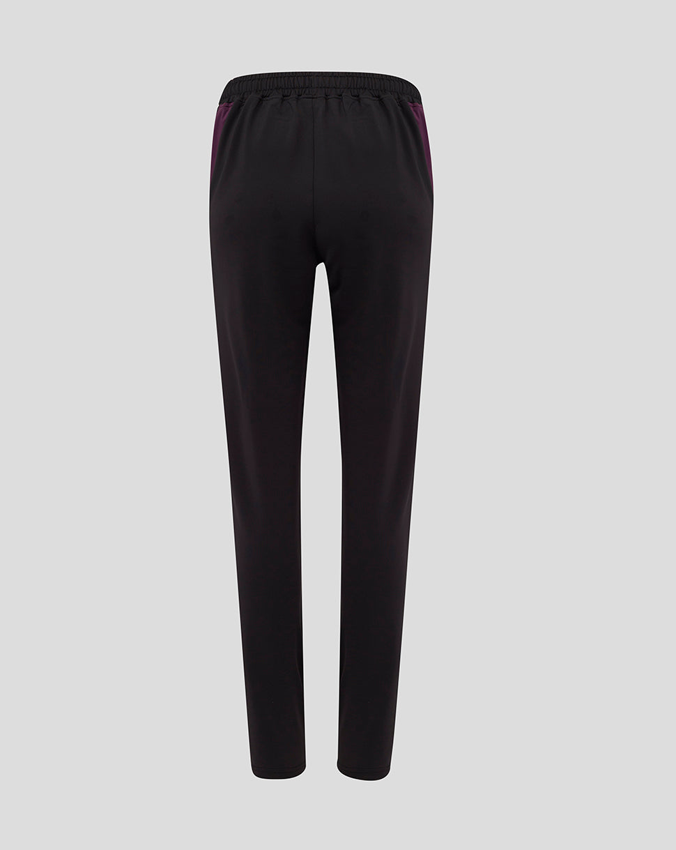 Back view of black training pants with a purple side stripe and a light blue crest on the left hip.