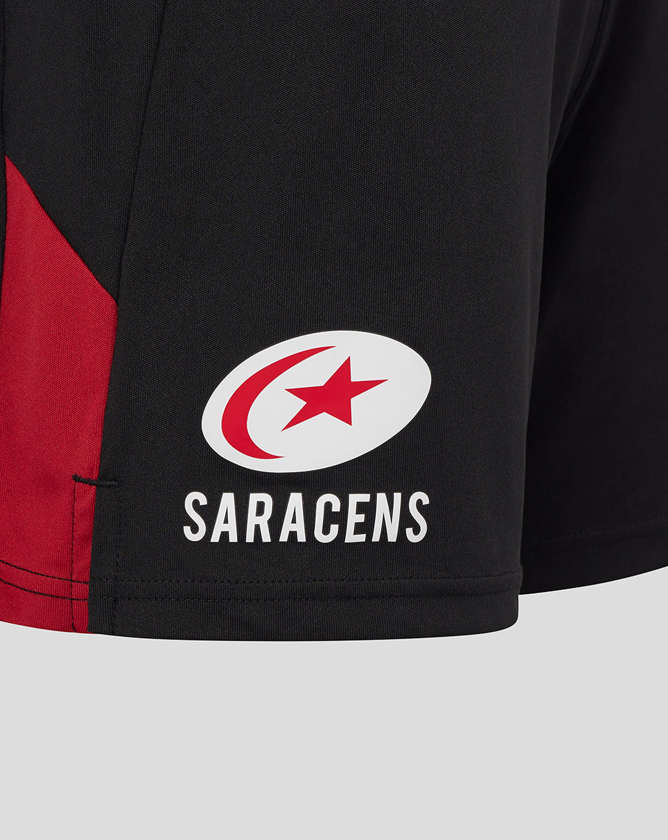 Close up of Saracens logo on black training shorts thigh.