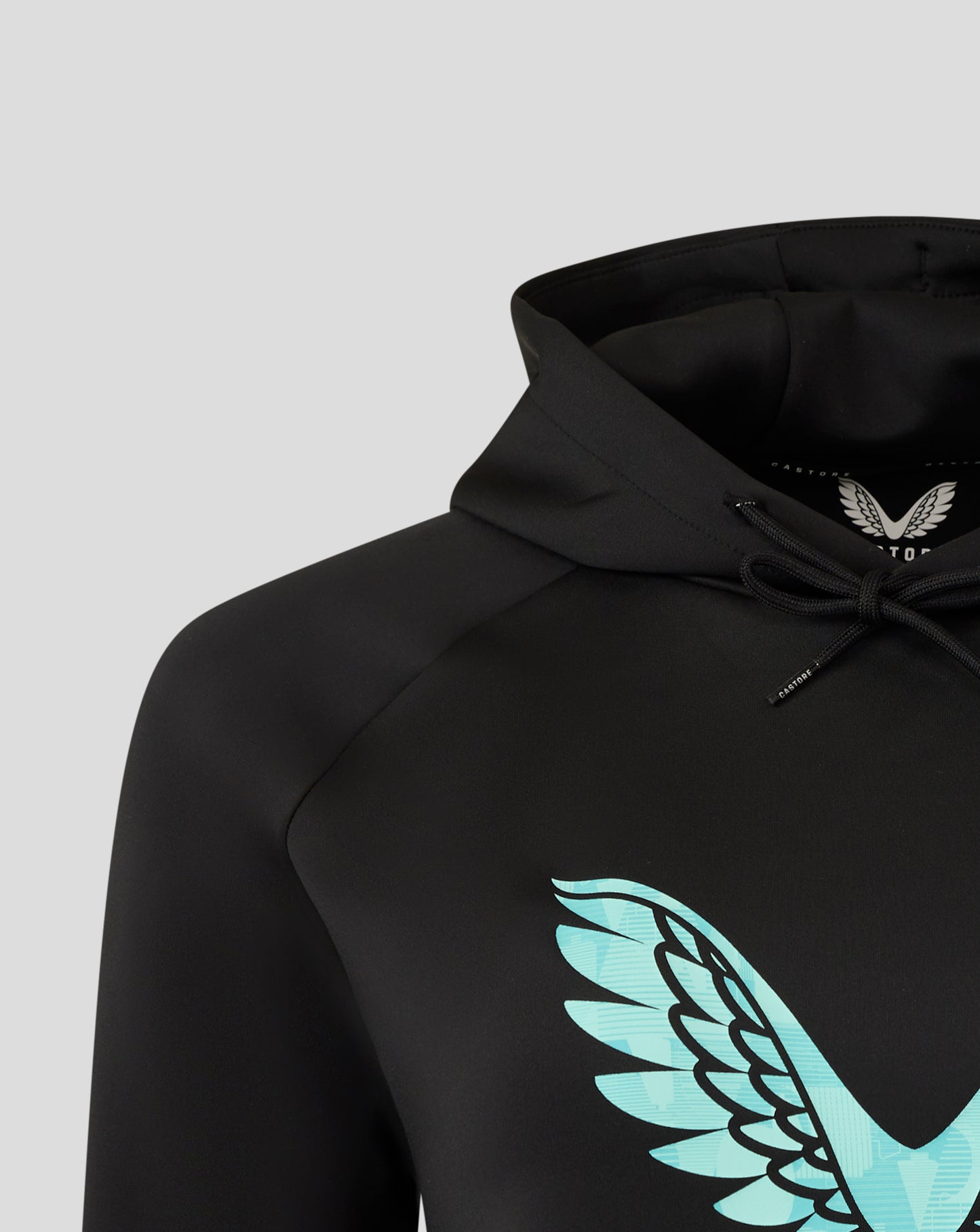 Close up of the black England Ashes women's hoodie focusing on the hood edge and interior label with wing emblem.