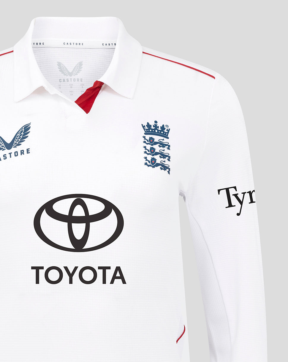 Close-up of the white Test Pro cricket shirt neck showing England crest, red inner placket, and Toyota logo on the chest.