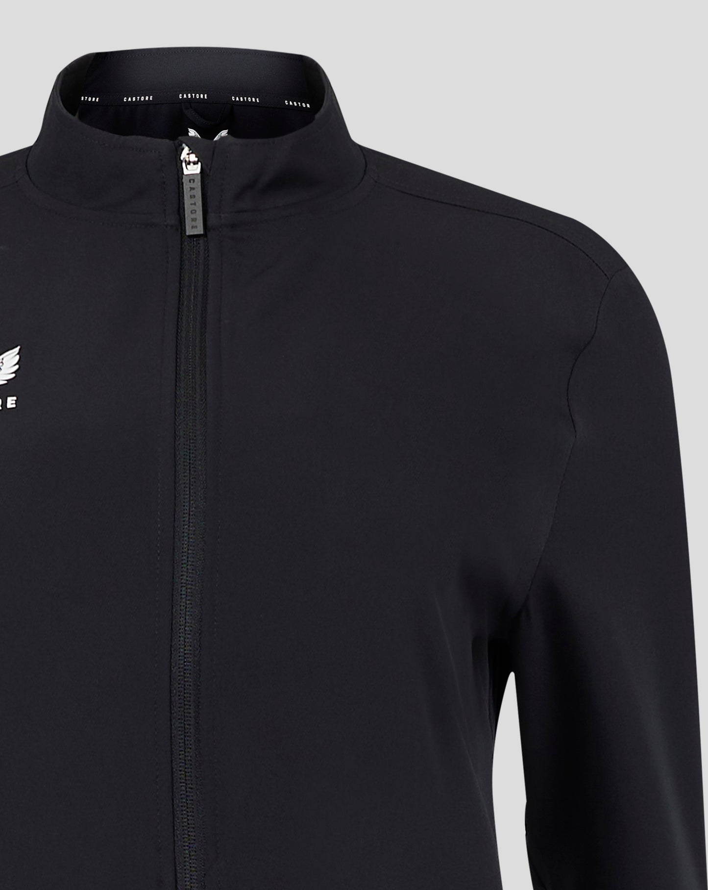 Zippered front of black jacket with visible white Castore logo on the left chest