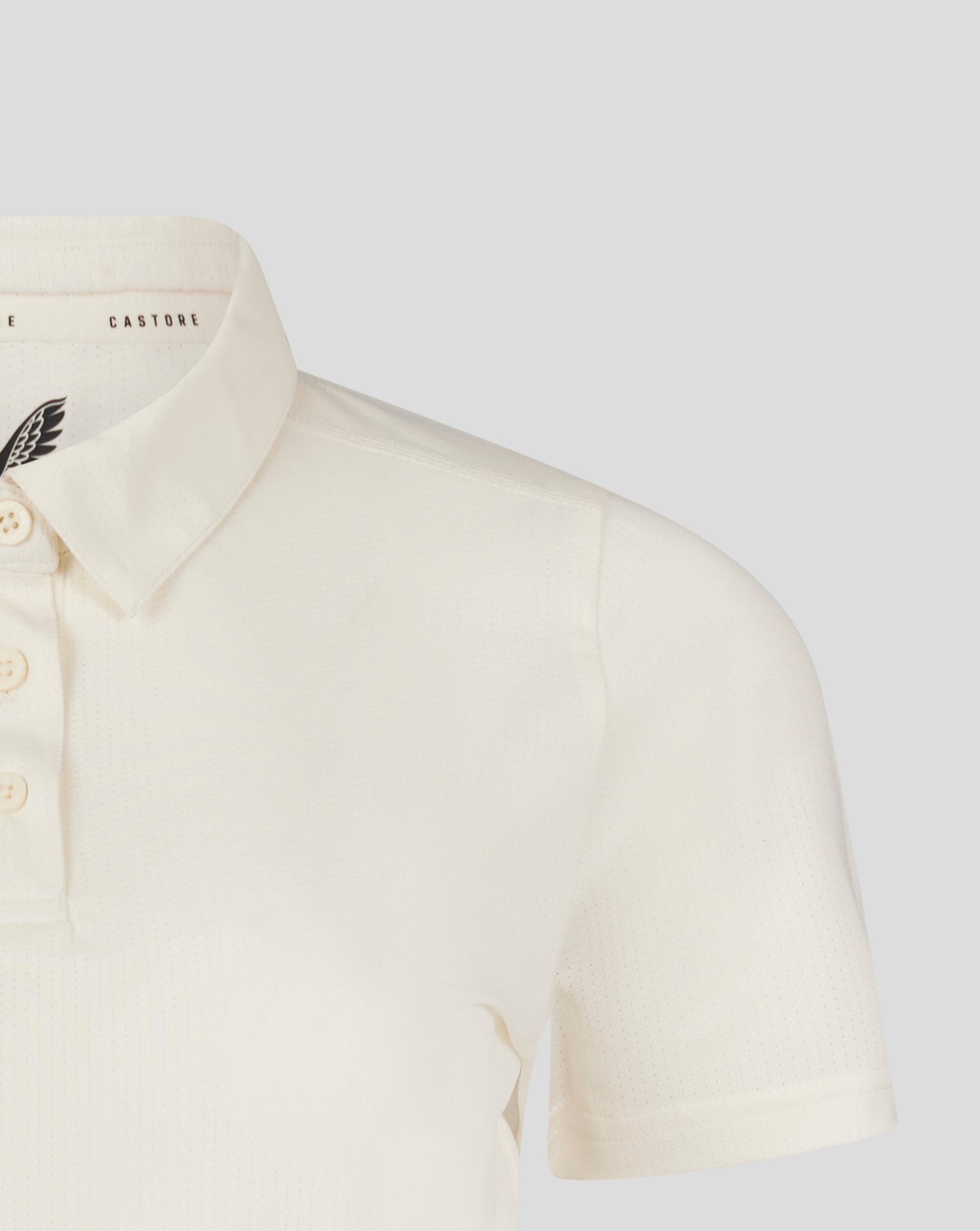 Cannoli Cream womens cricket tech playing shirt close up of collar and chest with Castore branding