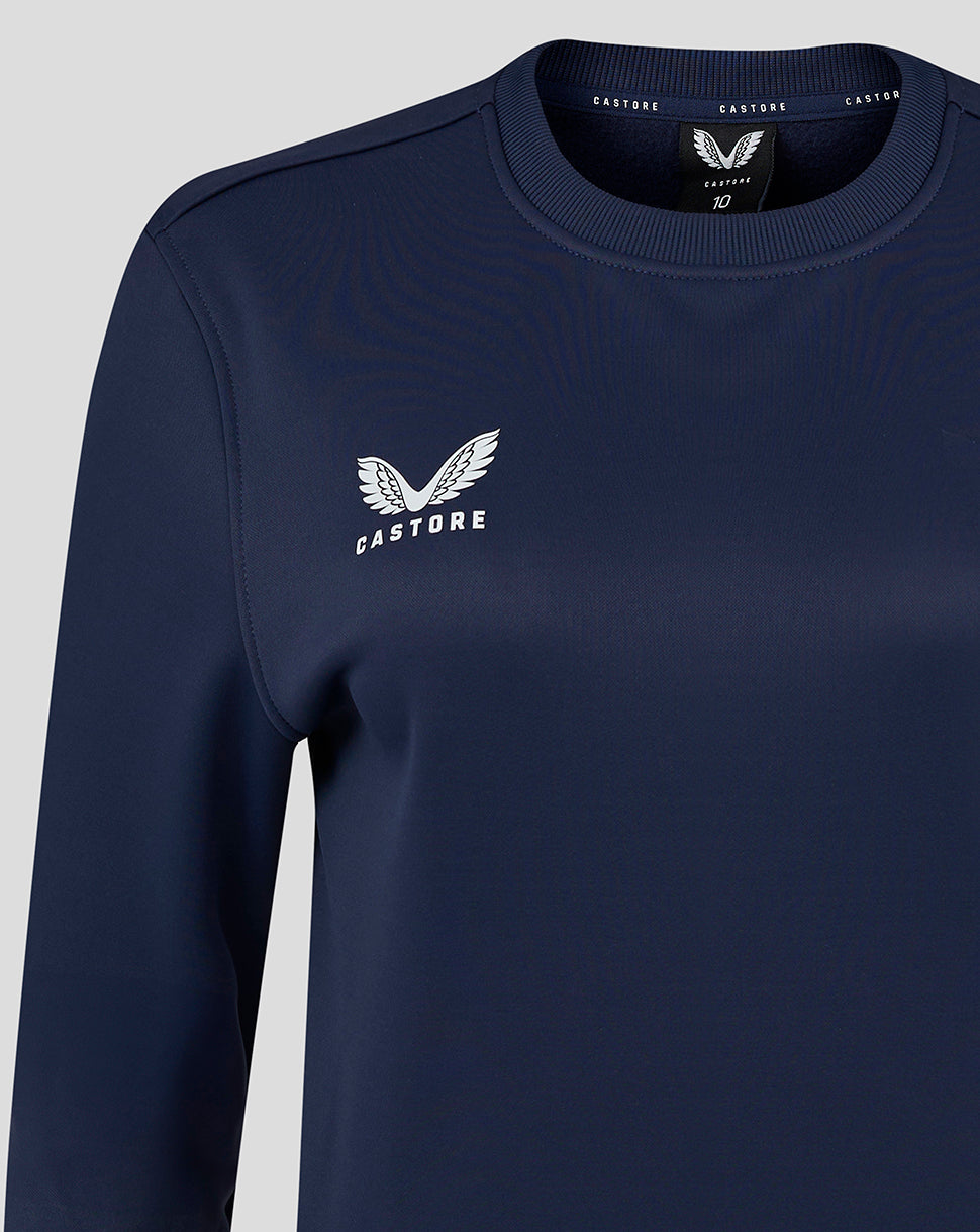 Womens brushback crewneck sweatshirt in peacoat navy with white Castore wing logo on chest.