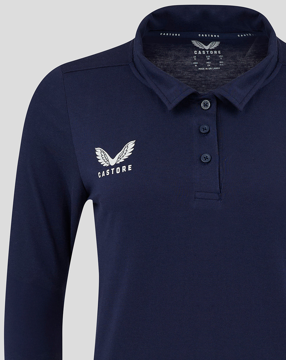 Closer view of navy polo at chest area with logo and shoulder seam detail