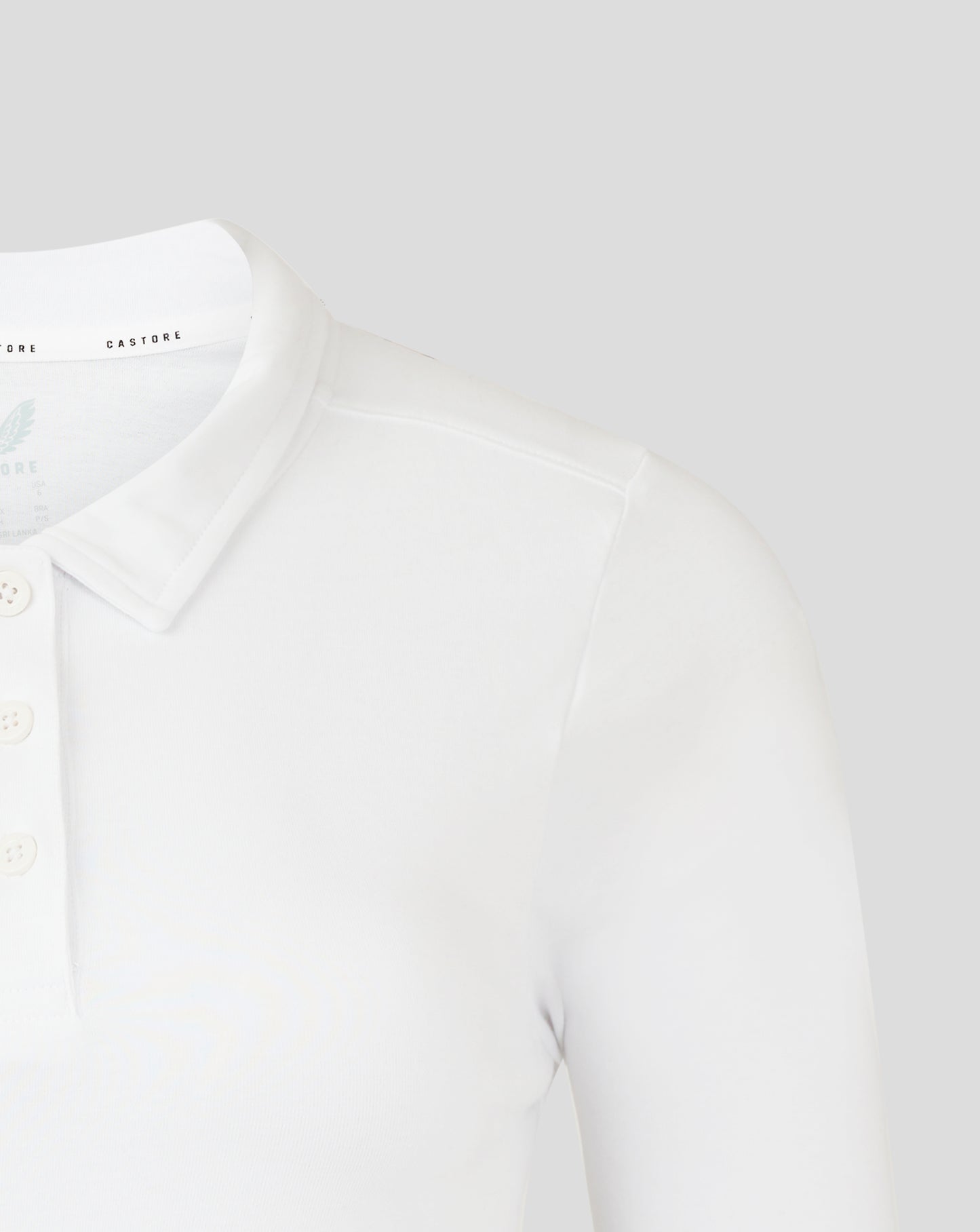 White polo close up showing collar and Castore branding along the neck.