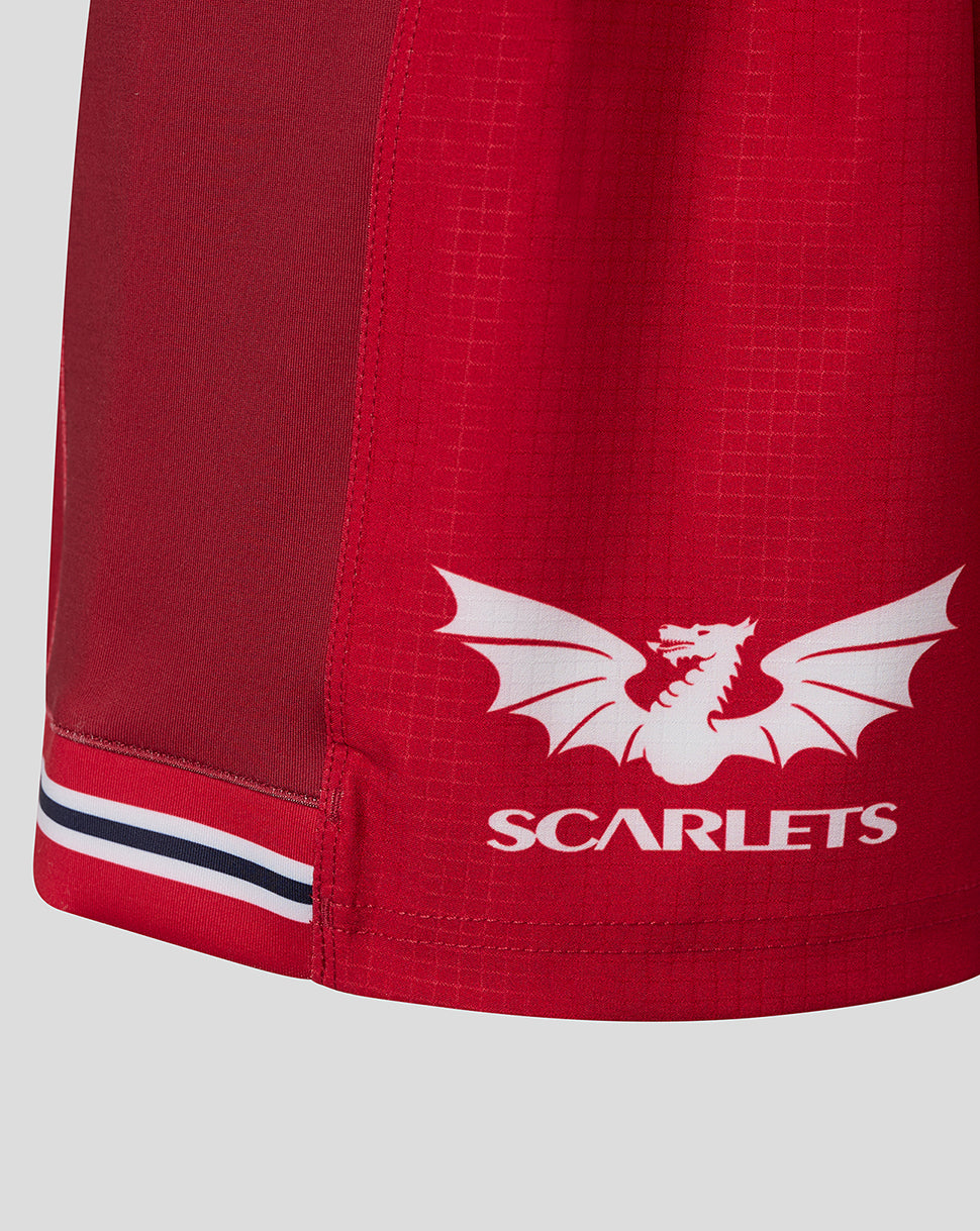 Close-up of Scarlets crest and text on red shorts hem with stripe detail