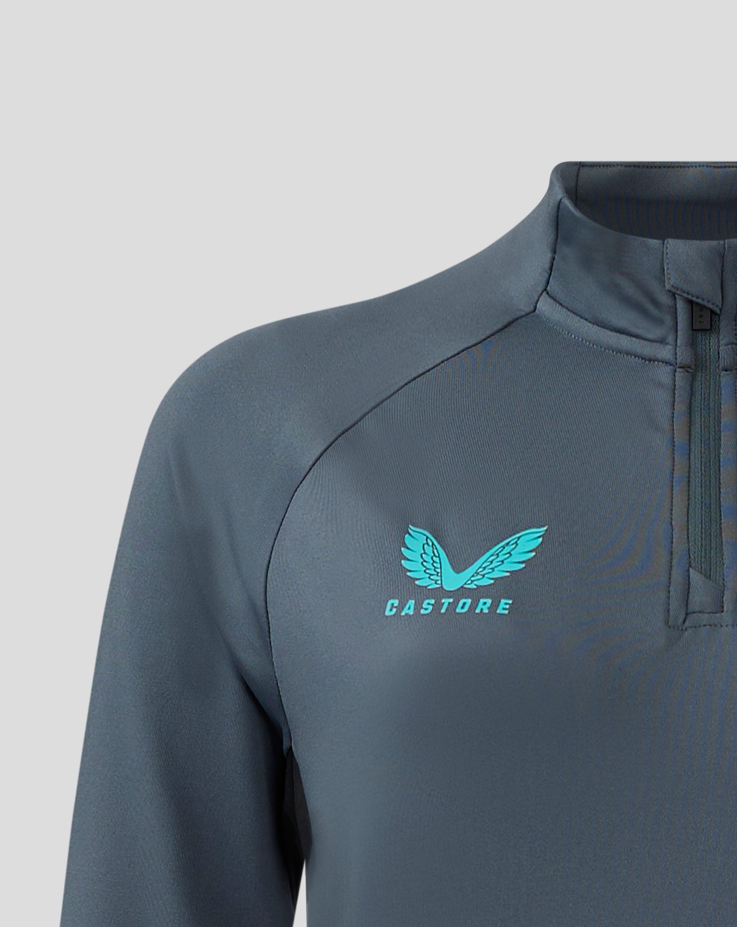 Front close up of Bath Rugby Women's Quarter Zip with teal crest on left chest and Castore branding on right chest