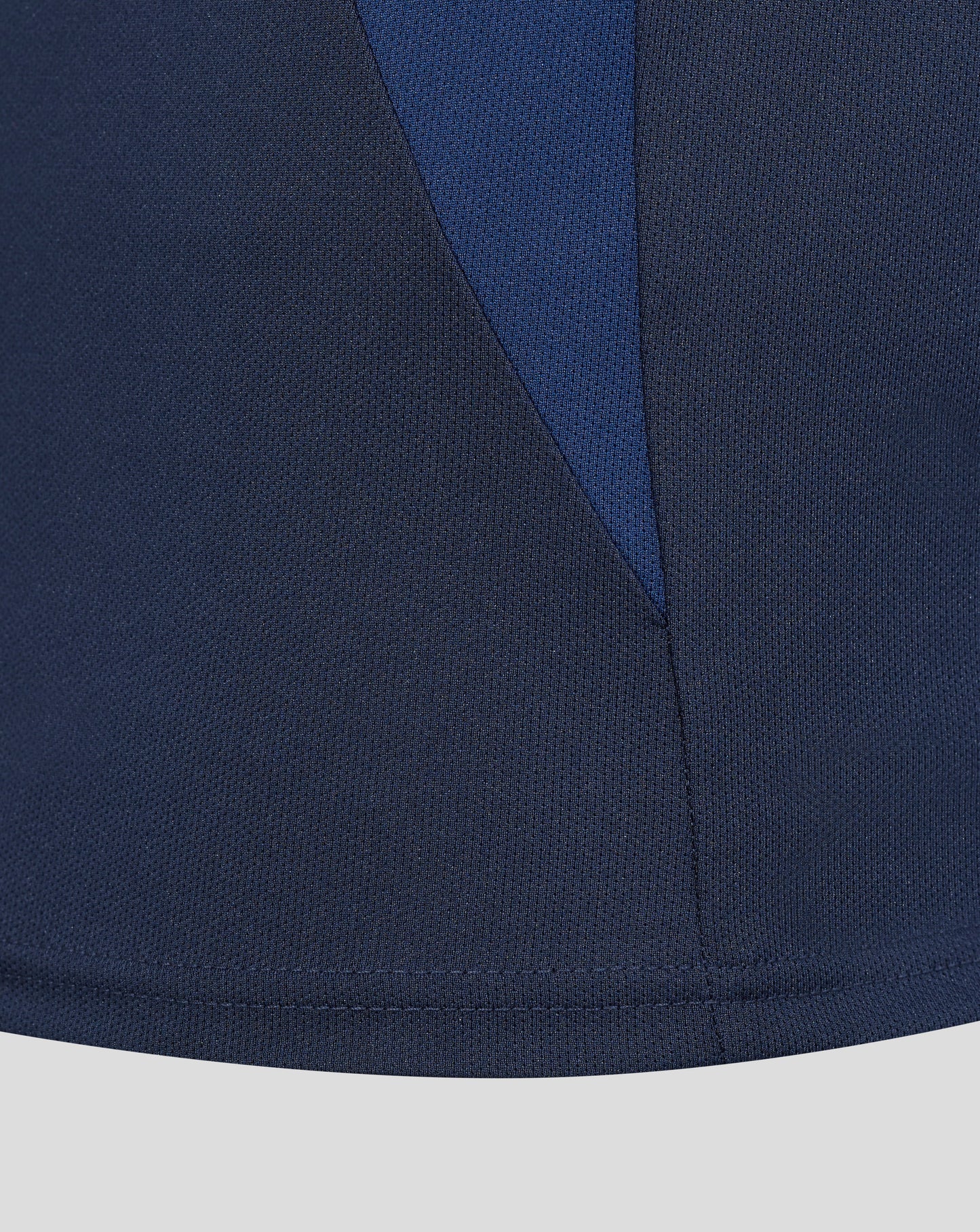 Close up of navy blue fabric with a diagonal seam from the Sydney Roosters 2025 women's pro players presentation polo
