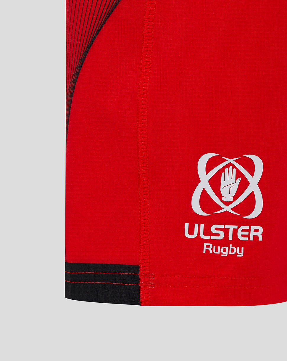 Close-up of red shorts side with Ulster Rugby logo and black trim near the hem
